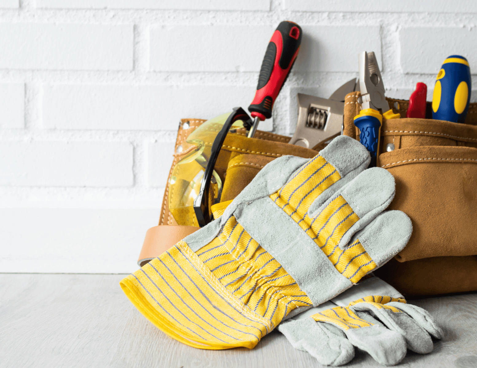 http://Construction%20gloves%20and%20tool%20belt%20with%20screwdrivers,%20pliers,%20and%20safety%20glasses